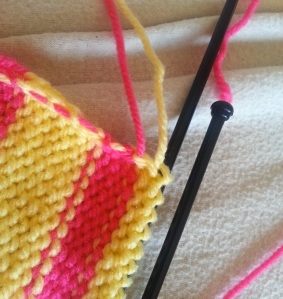 Here you can see how knit the edges are with the unused yarn being woven up the side.