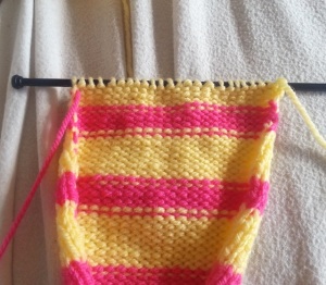 Once you get to the end of the row you will have the unused yarn on the left and the working yarn on the right.  Simply knit another row as normal.  Repeat the process when you start the next row.